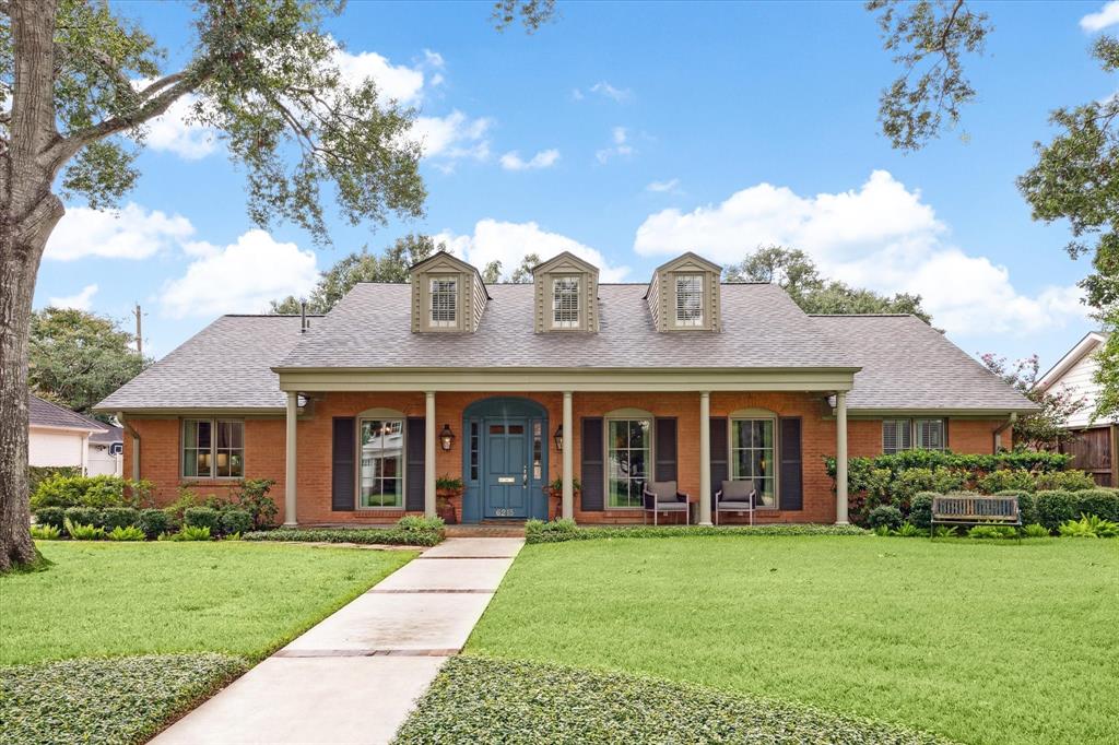 front view of a brick house with a yard