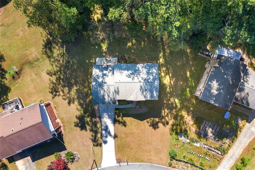 an aerial view of a house with a yard