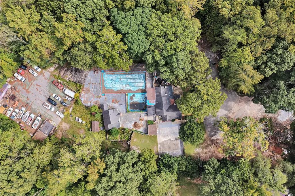 an aerial view of a house with a yard basket ball court and outdoor seating