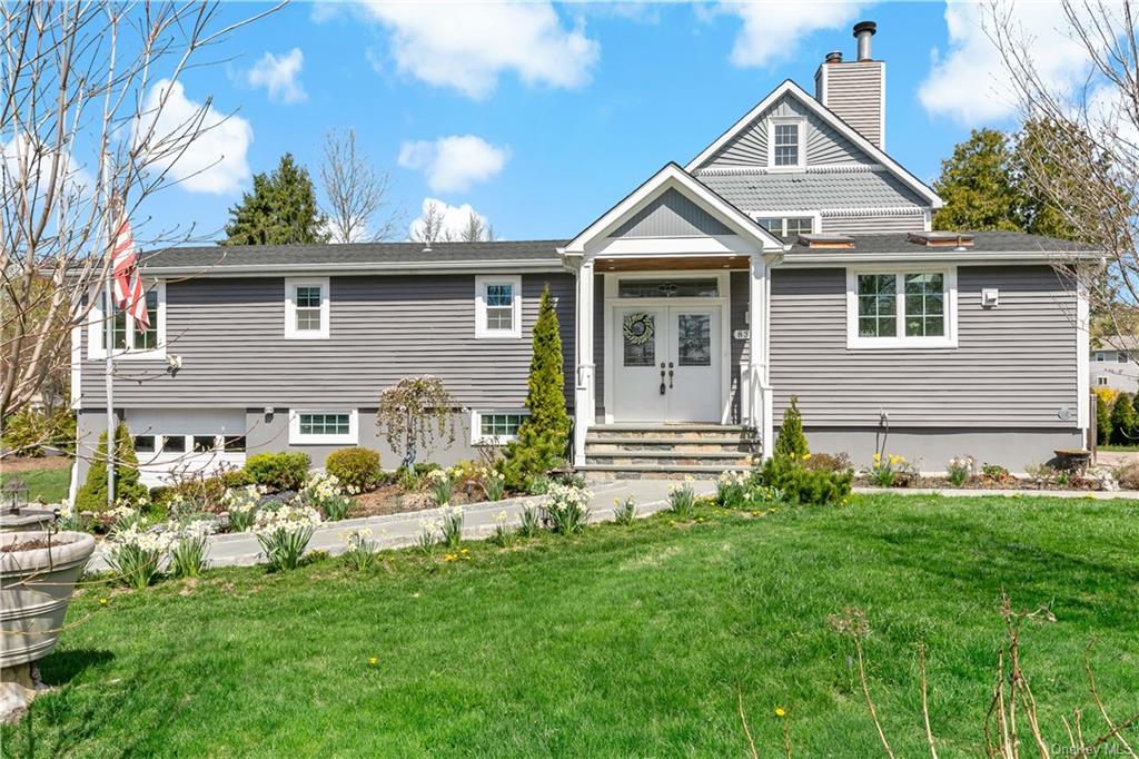 a front view of a house with a garden