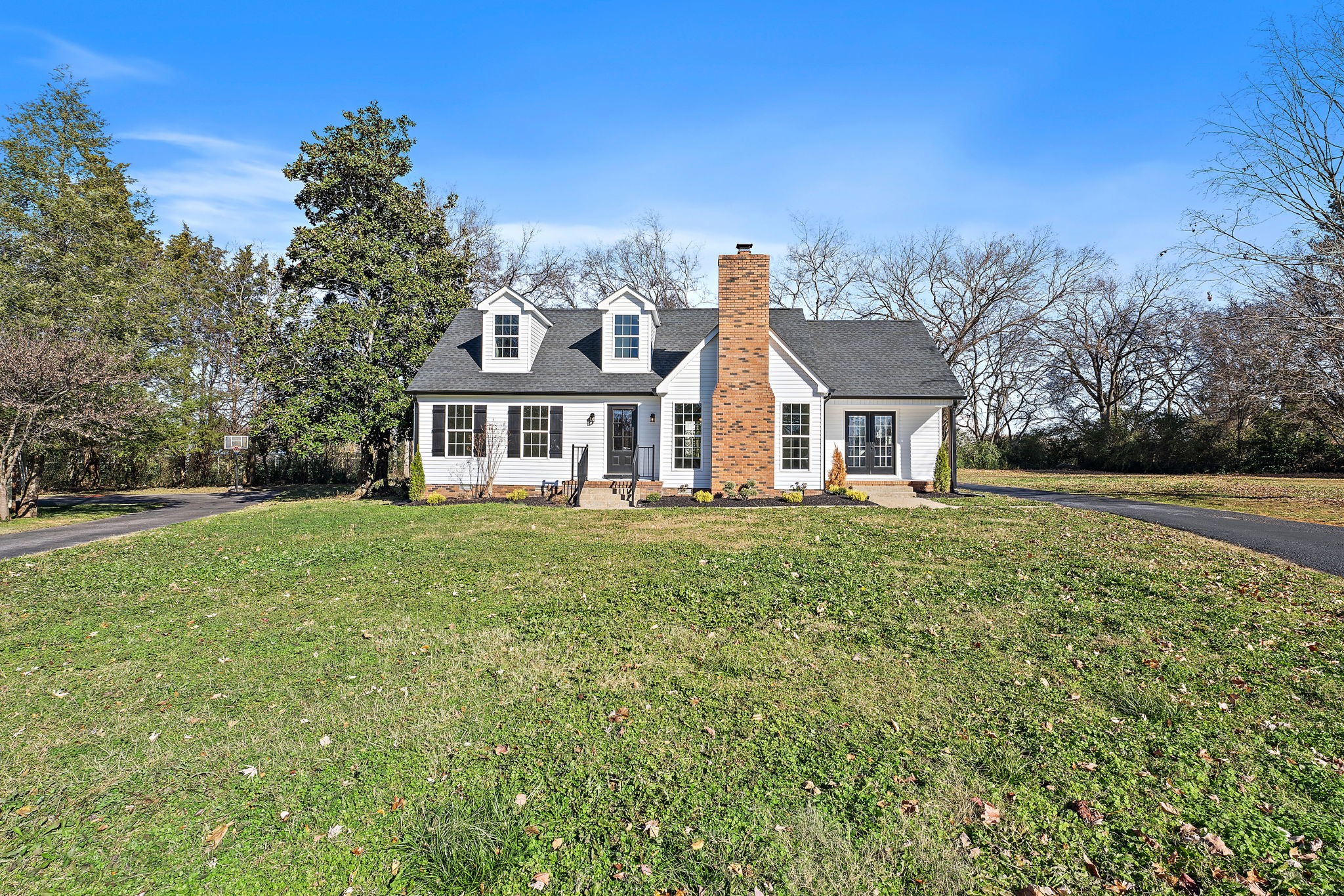 a front view of a house with a garden