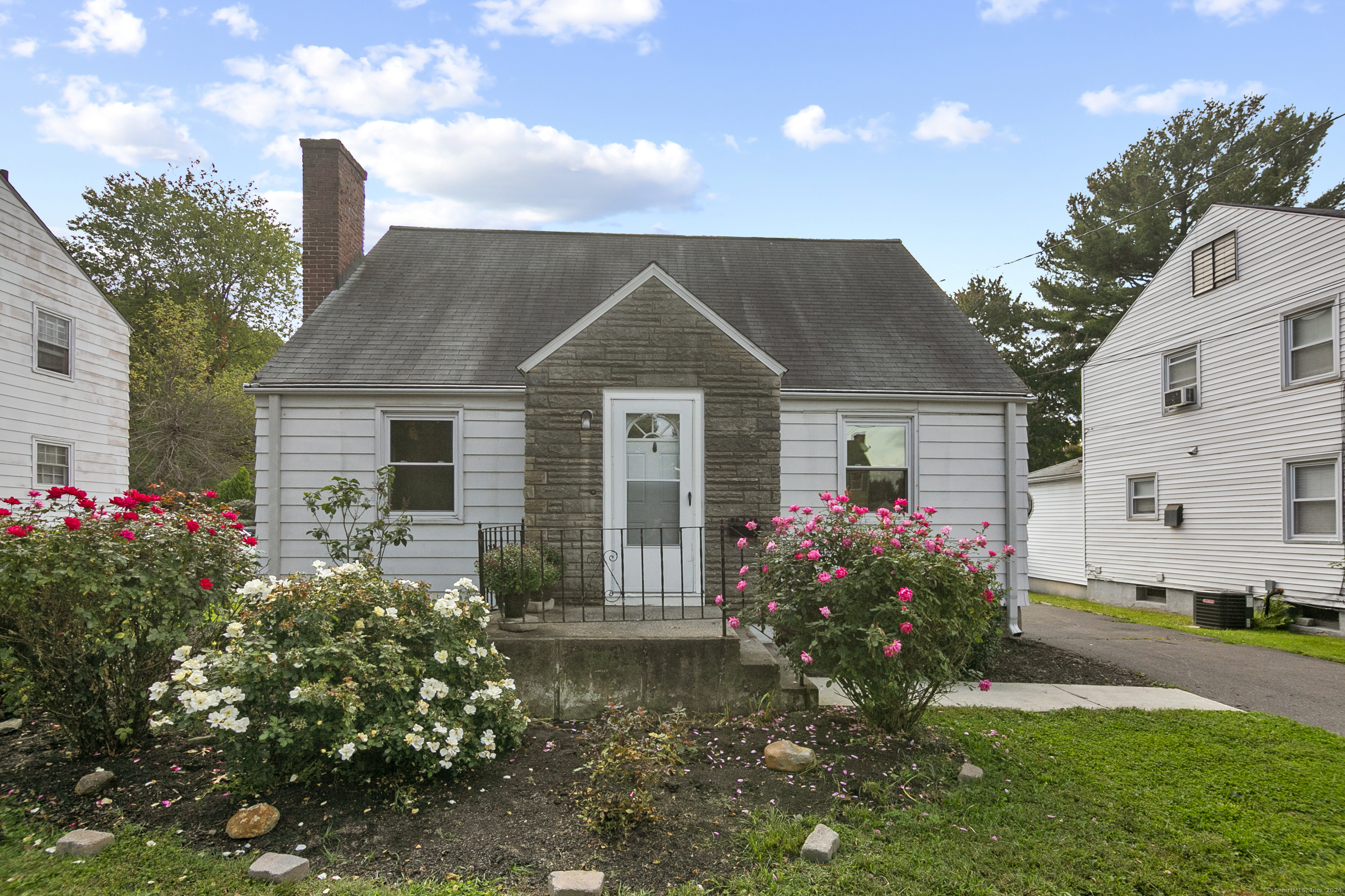 a front view of house with yard and trees