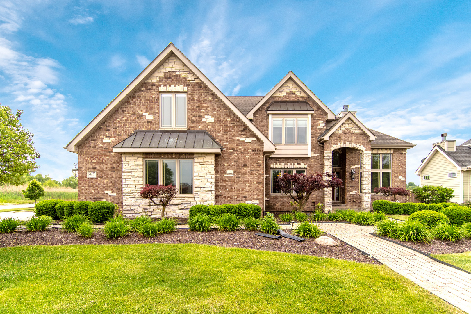 a front view of house with yard and green space