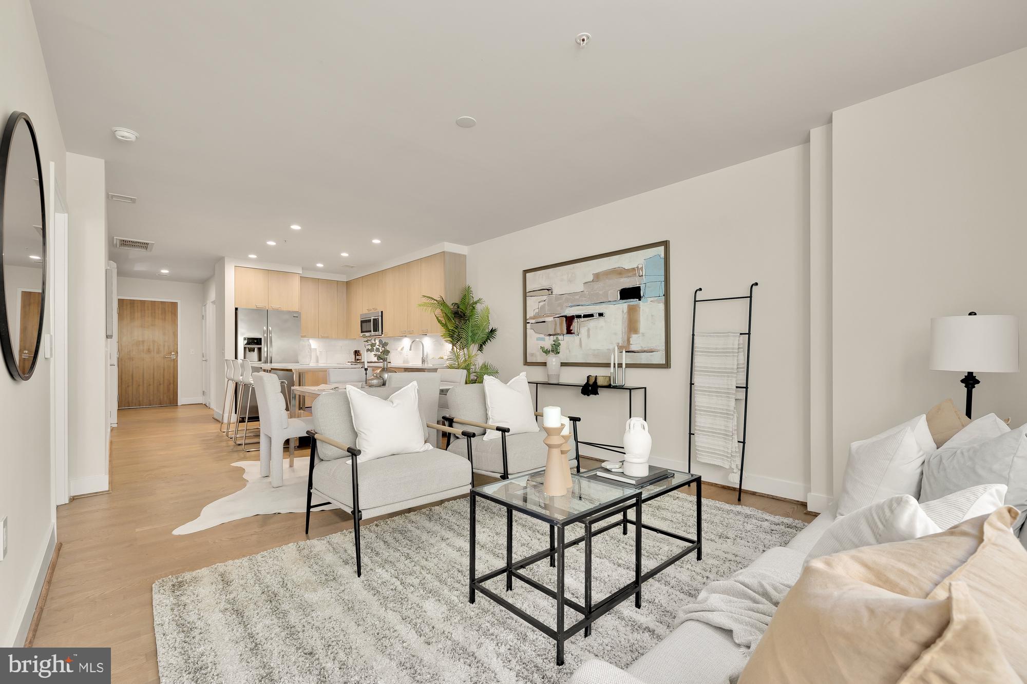 a living room with furniture and kitchen view