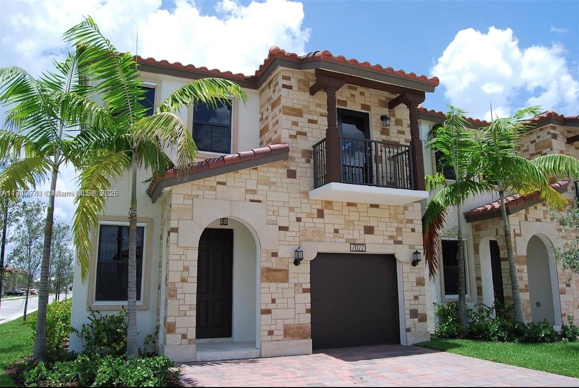 a front view of a house with a garden