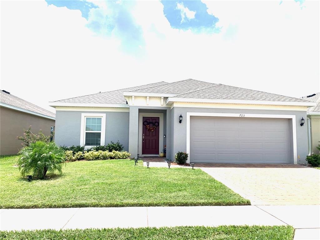 a front view of a house with a yard