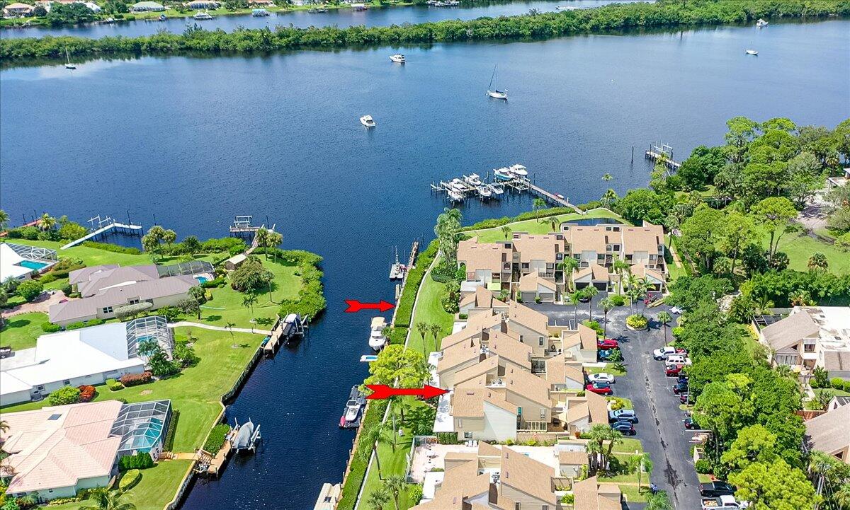 an aerial view of a house with a yard and lake view