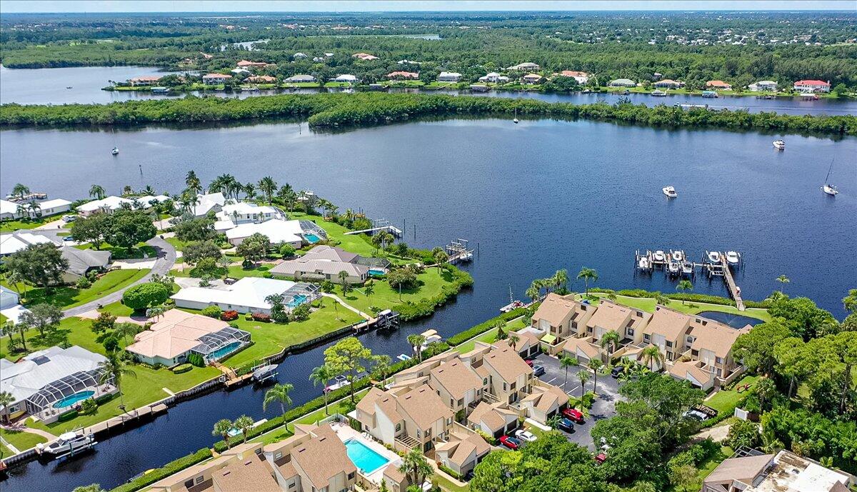 an aerial view of lake and residential houses with outdoor space