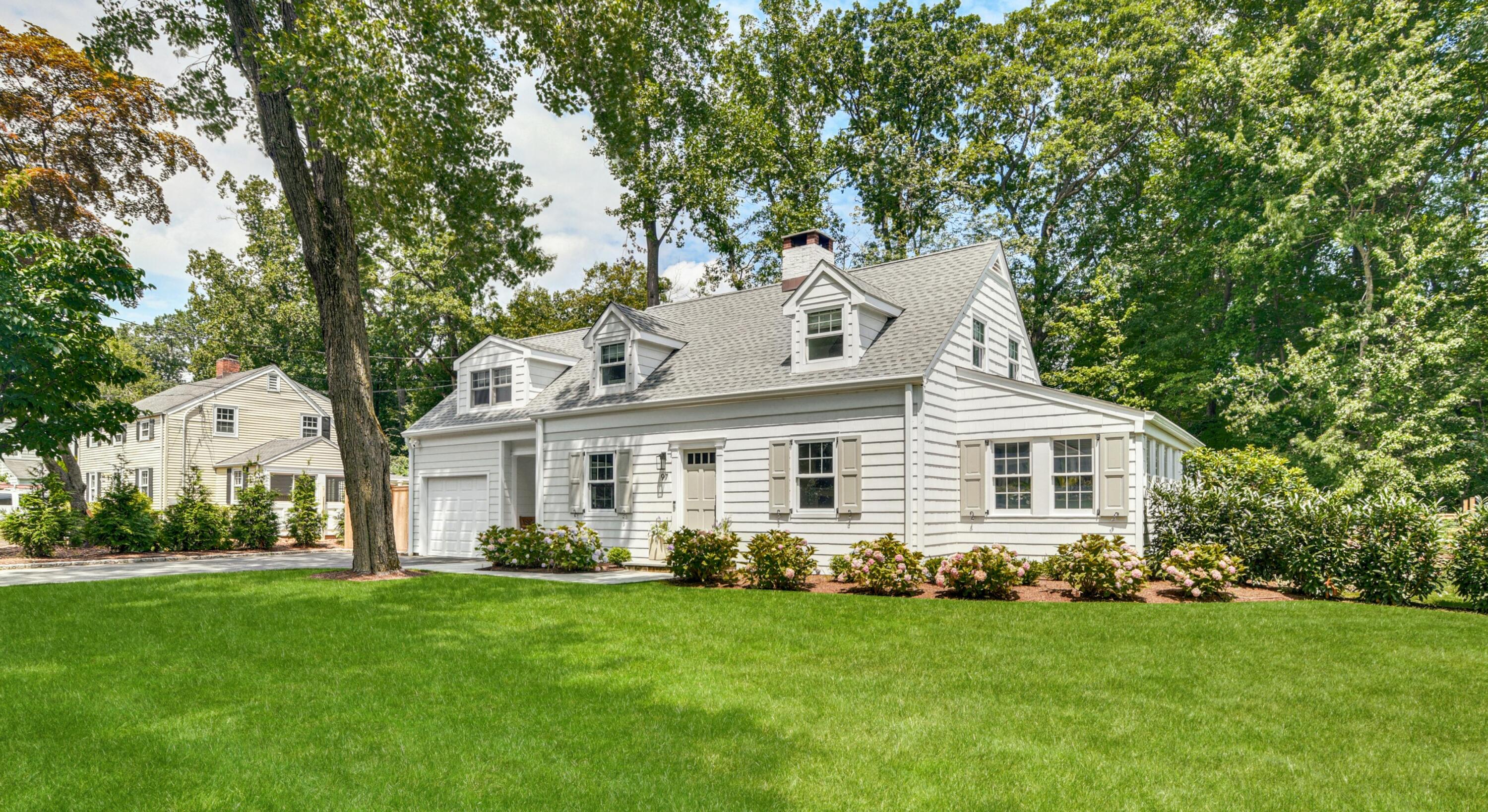 a front view of a house with a garden