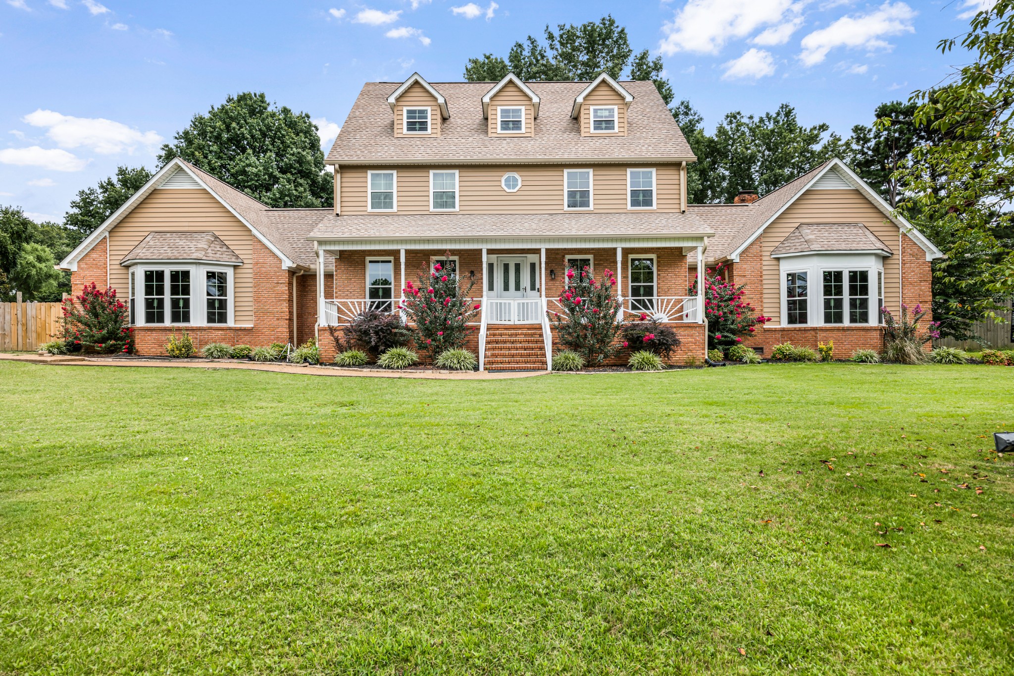 a front view of a house with a yard