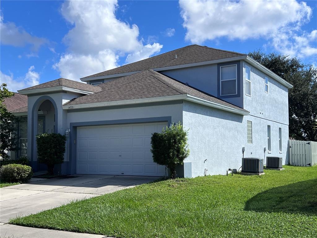 a front view of house with a garden