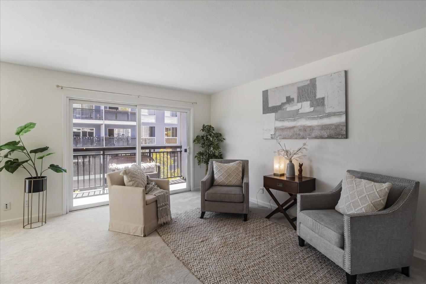 a living room with furniture and a potted plant