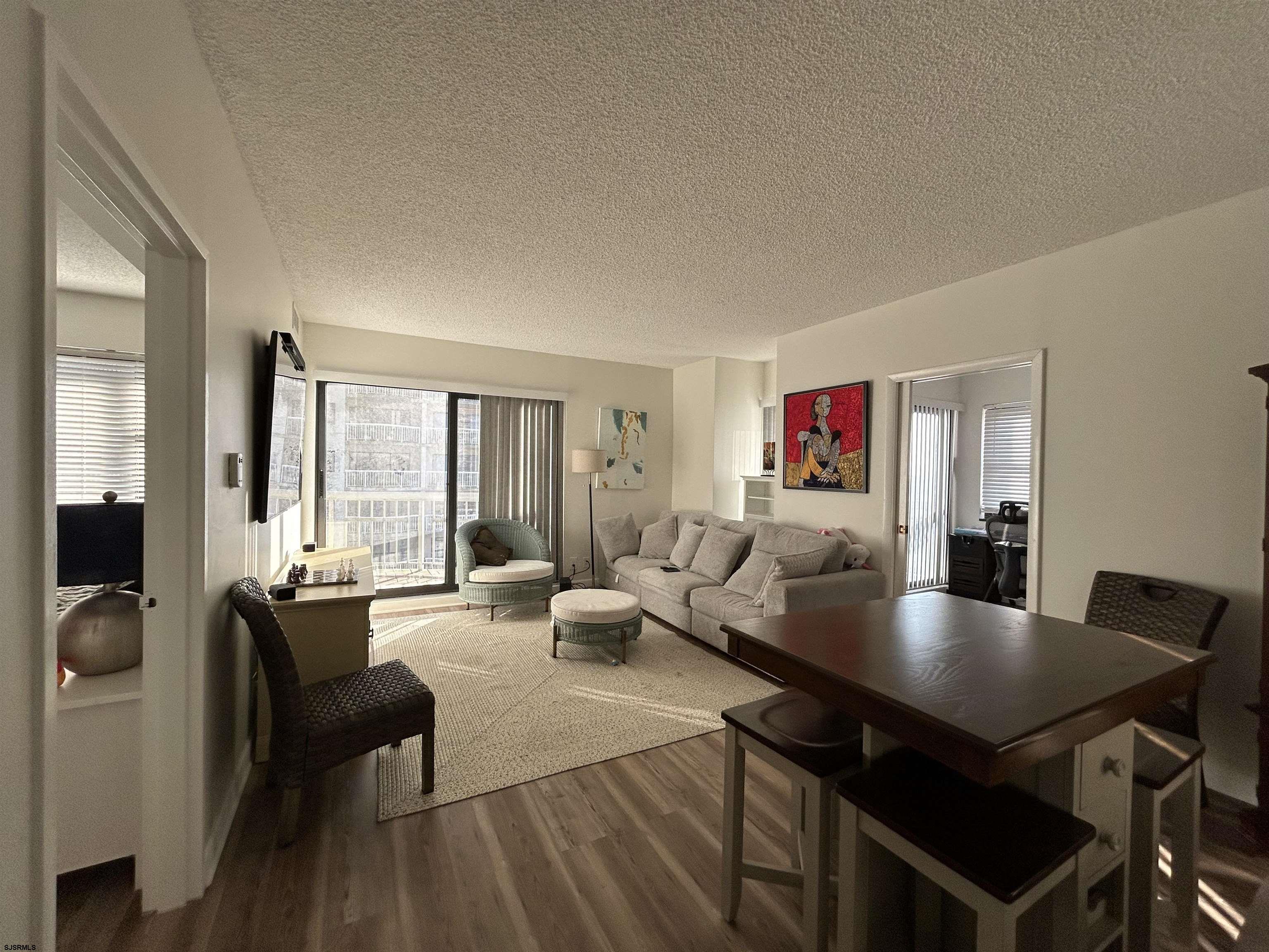 a living room with dining room and kitchen view