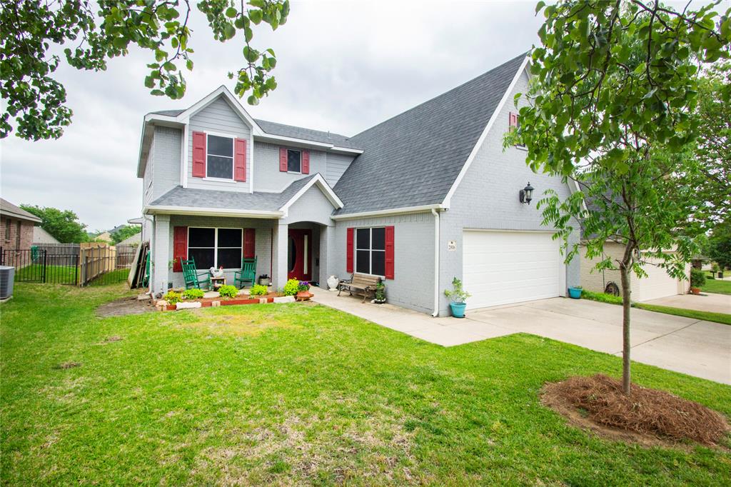 a front view of a house with sitting area and garden