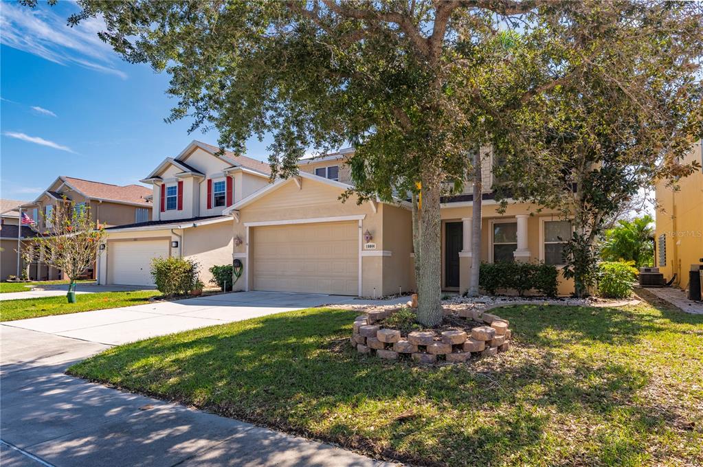 a front view of a house with a yard and garage