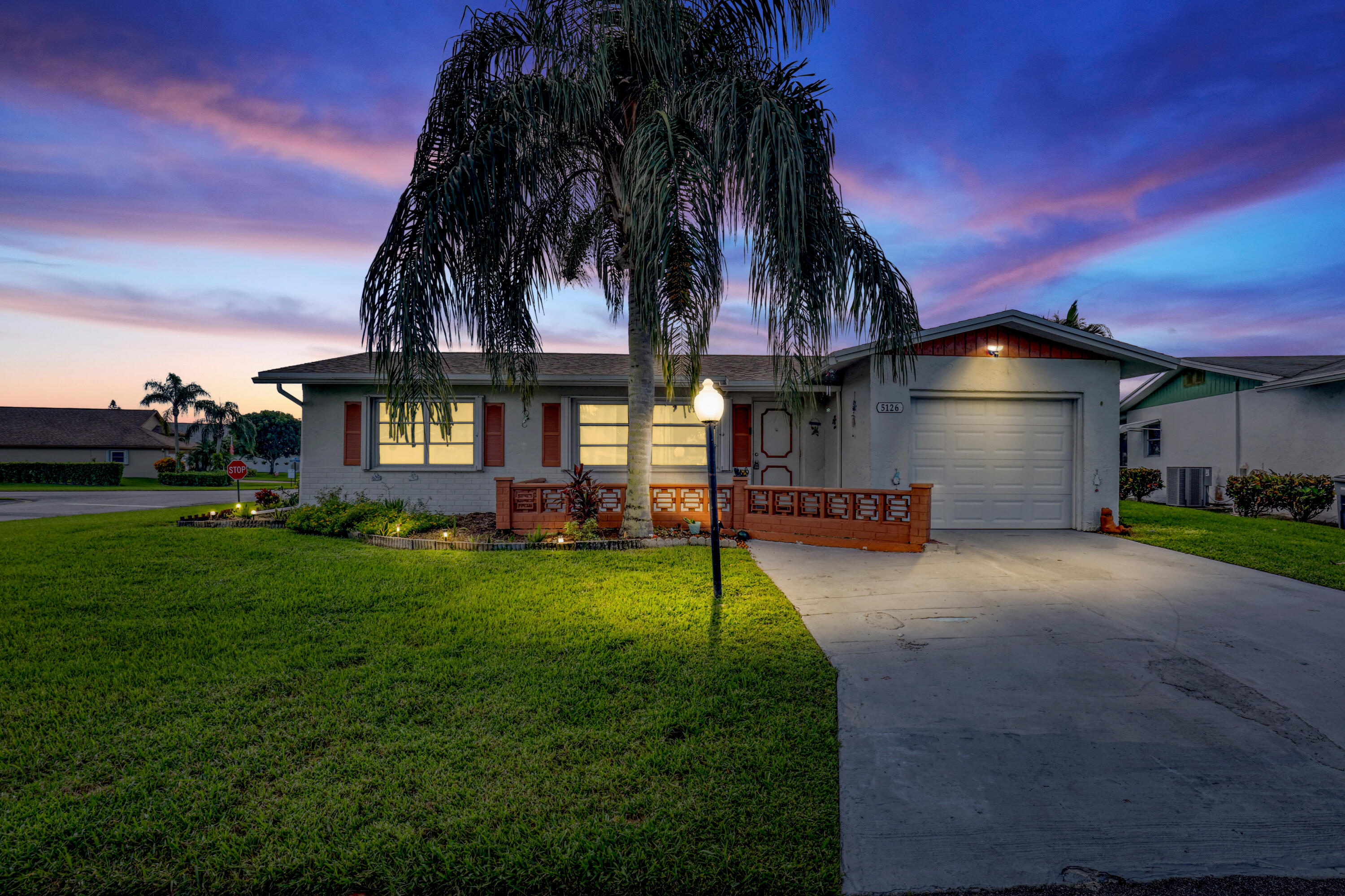 a front view of a house with a garden and a yard