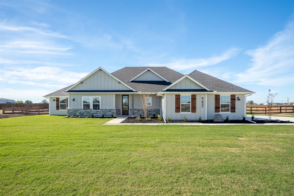 a front view of a house with a big yard