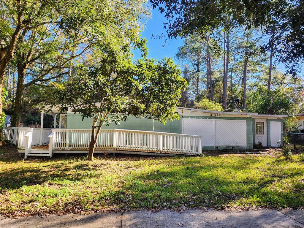 a view of a backyard with large trees