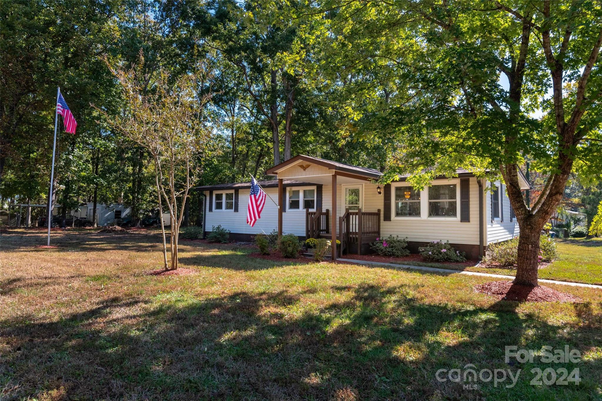 a view of house with outdoor space and tree s