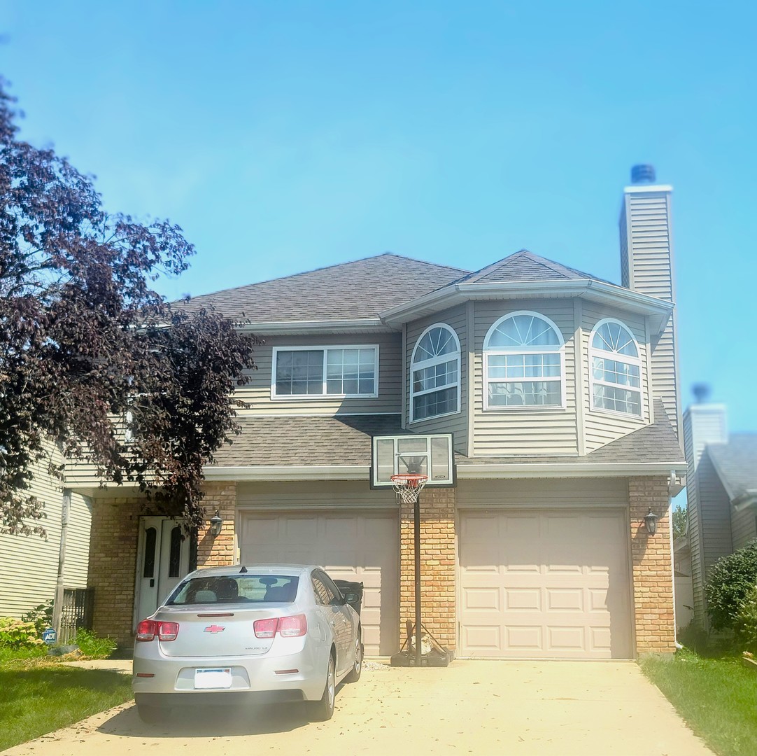 a front view of a house with garage