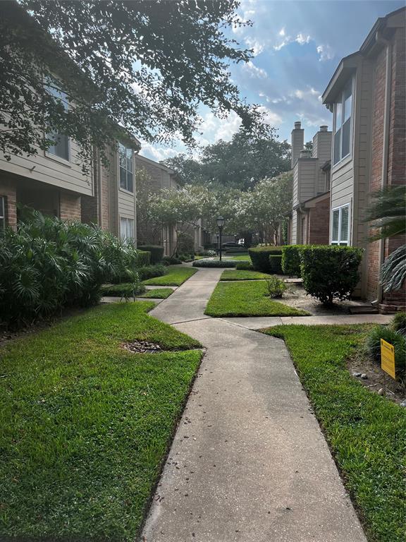 a view of a big yard next to a brick building