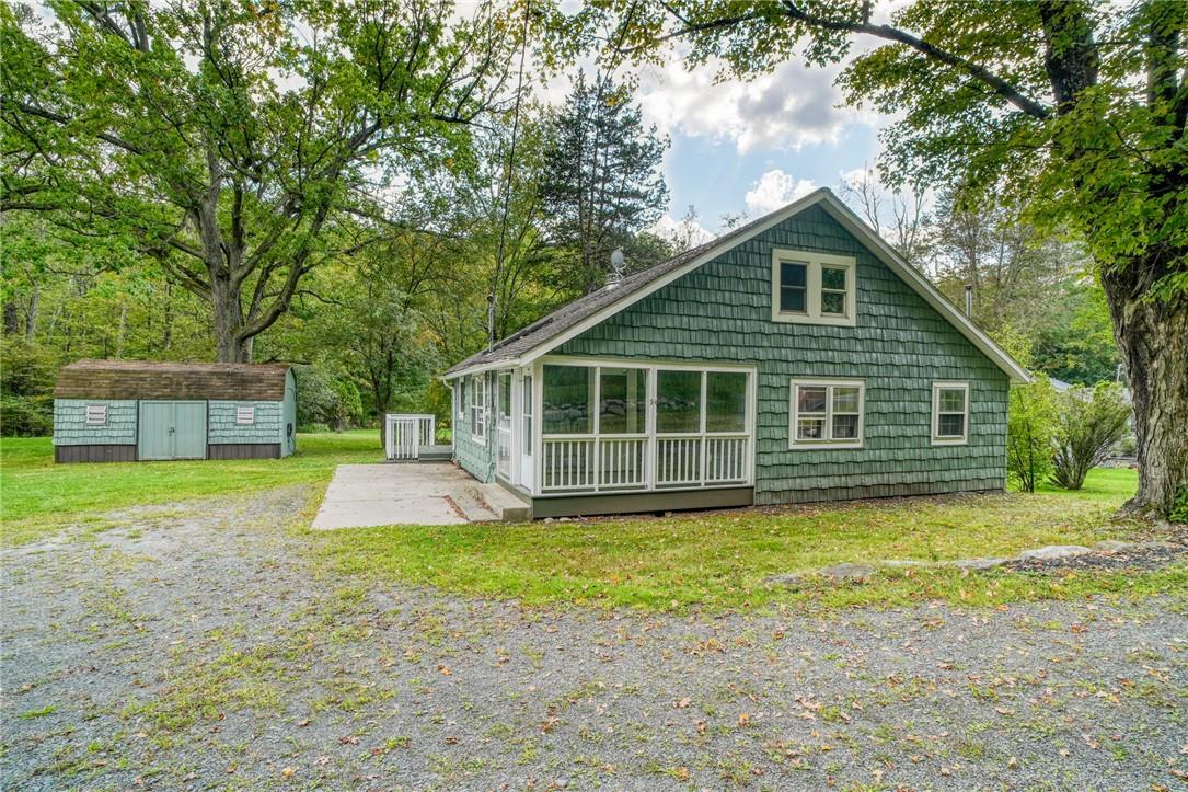 Back of property featuring a lawn