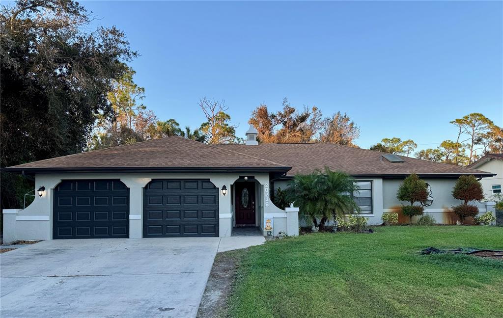 a front view of a house with a yard and garage