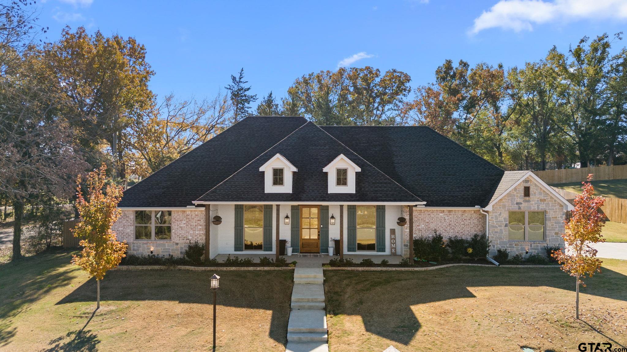 a front view of a house with garden