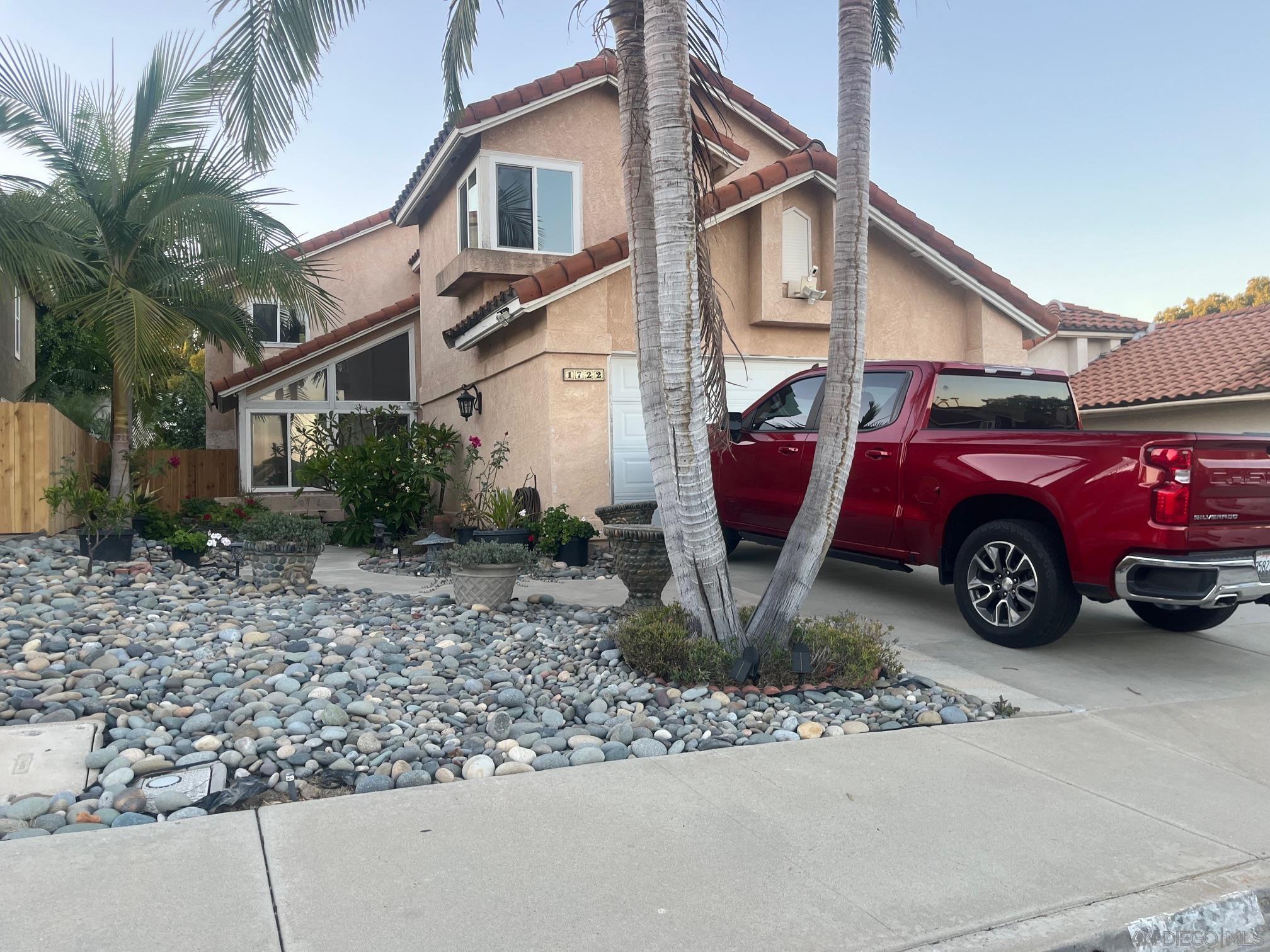 a front view of a house with parking space