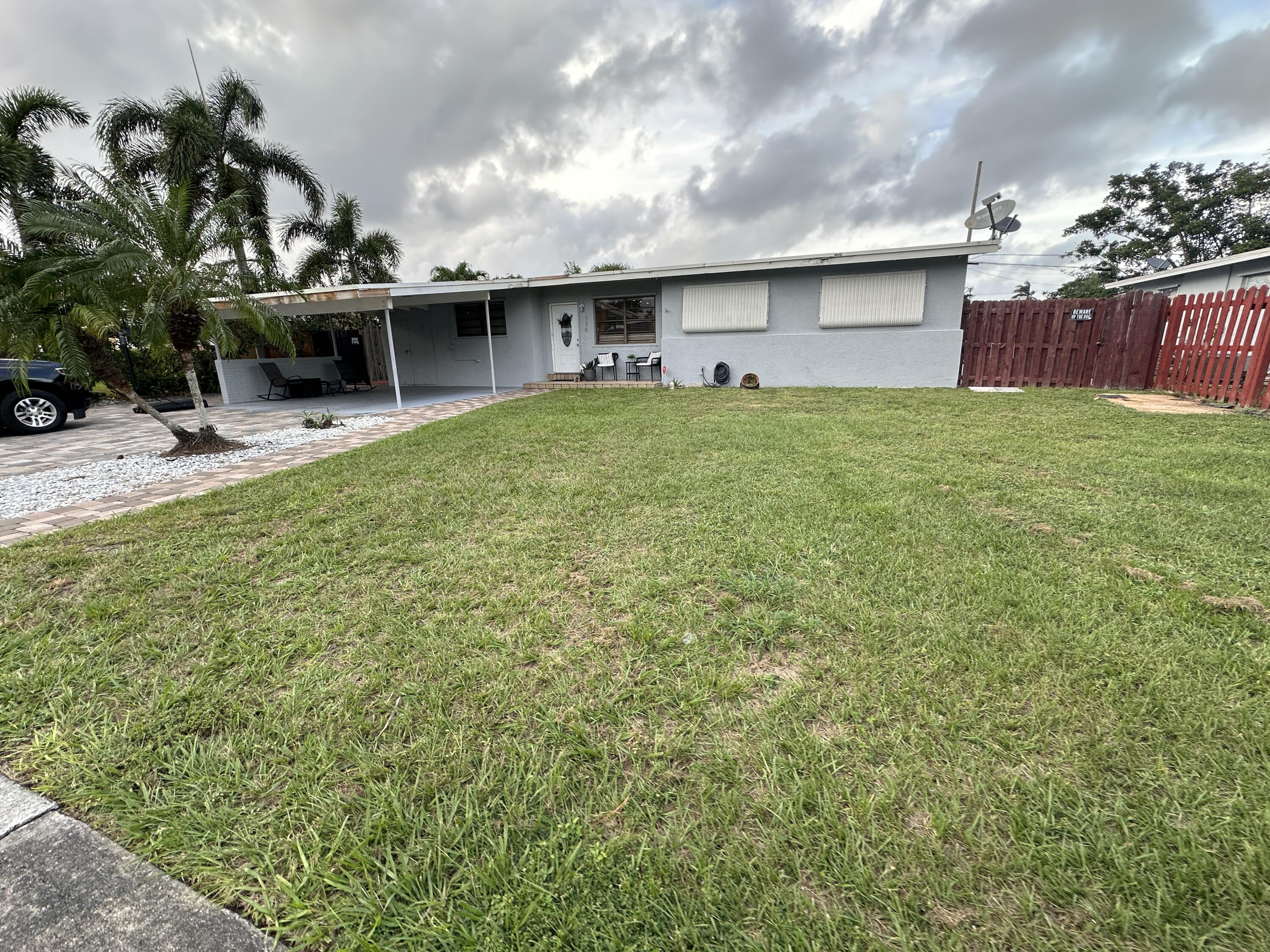 a front view of house with yard and outdoor seating