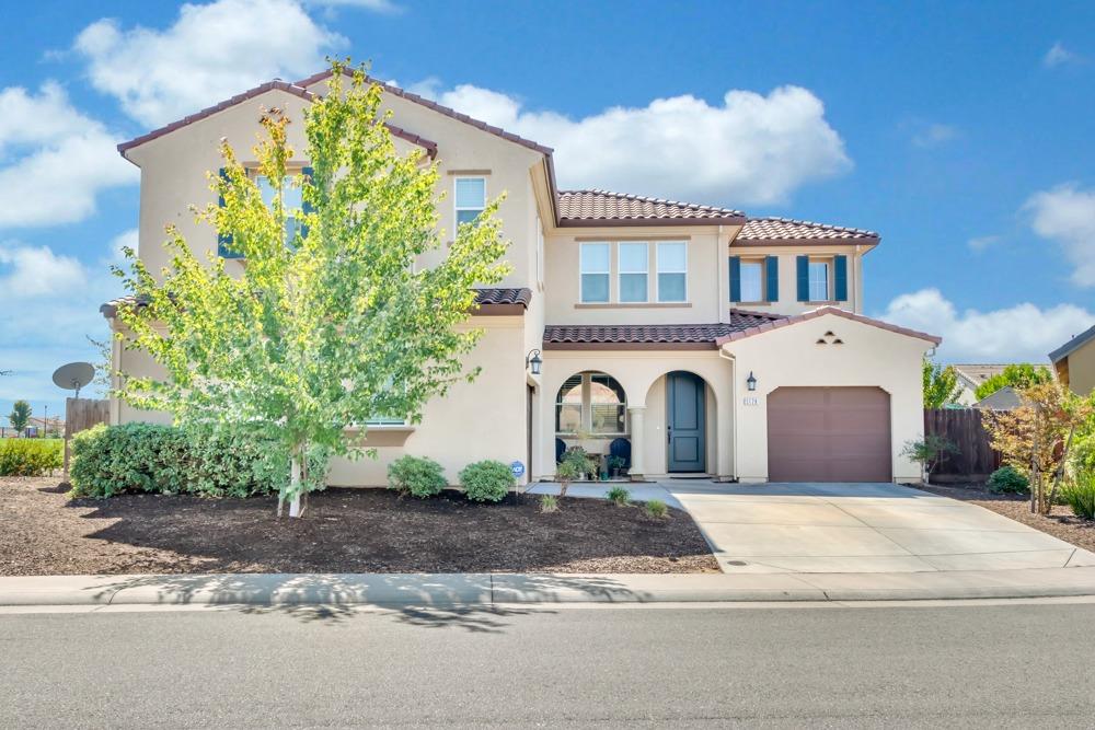 a front view of a house with a garden