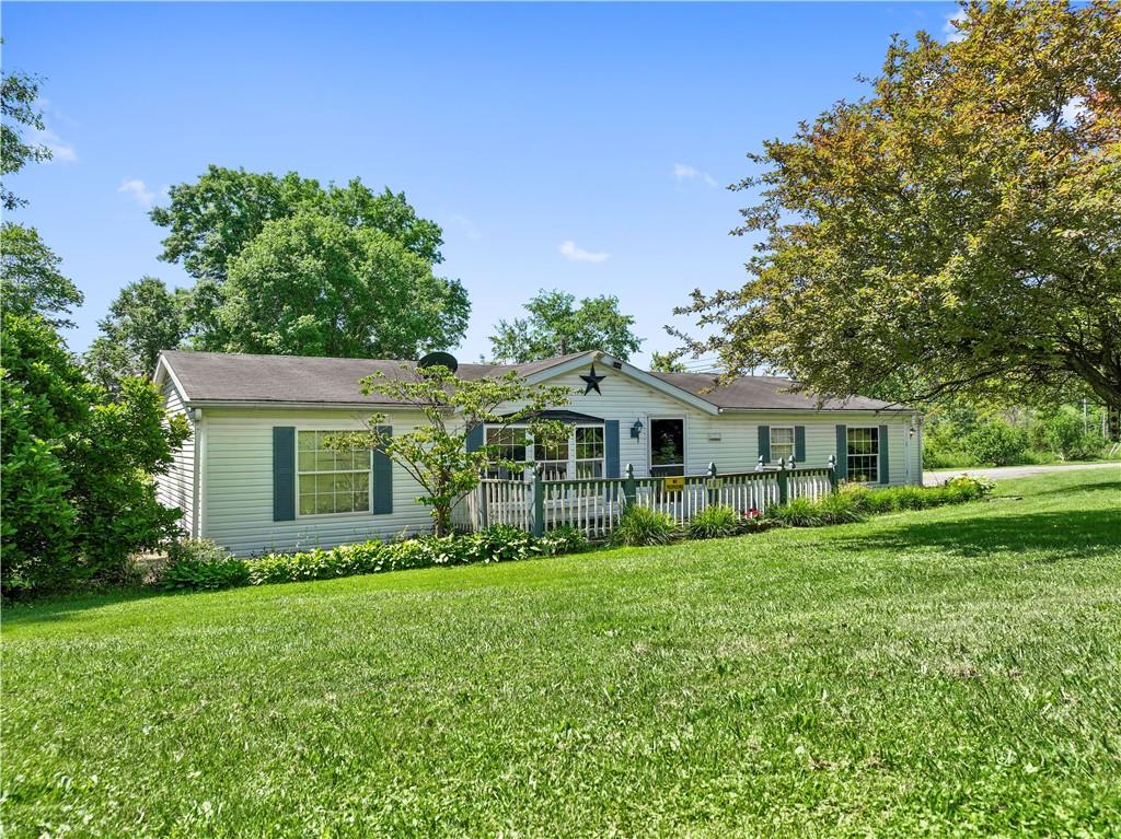 a front view of house with yard and green space