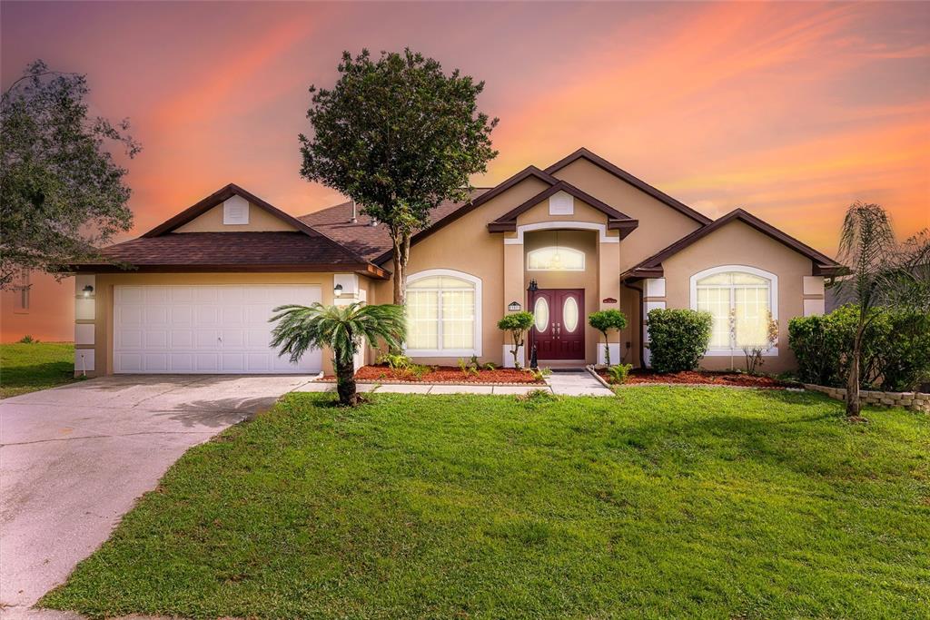 a front view of a house with a yard and garage