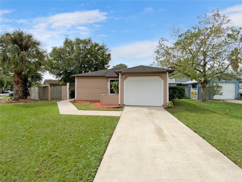 a front view of house with yard and trees