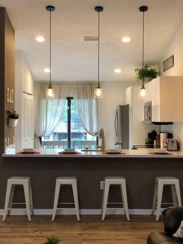 a kitchen with kitchen island granite countertop a sink a counter space and appliances