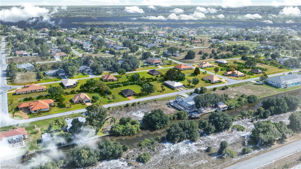 an aerial view of residential houses with outdoor space and trees