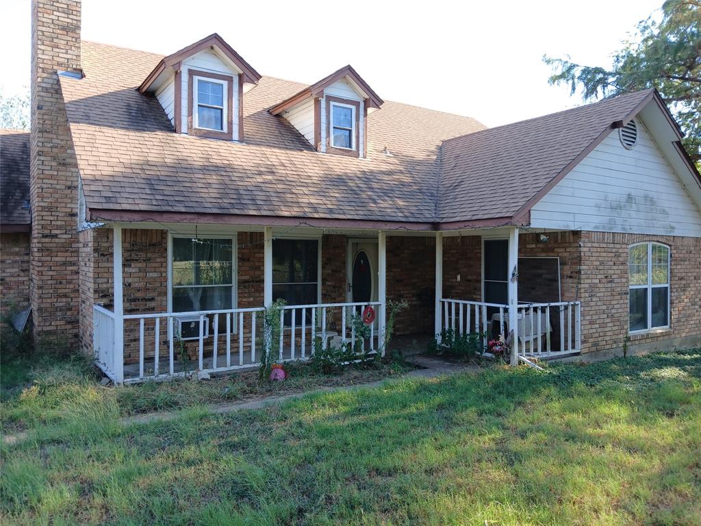 a view of a house with a yard and porch