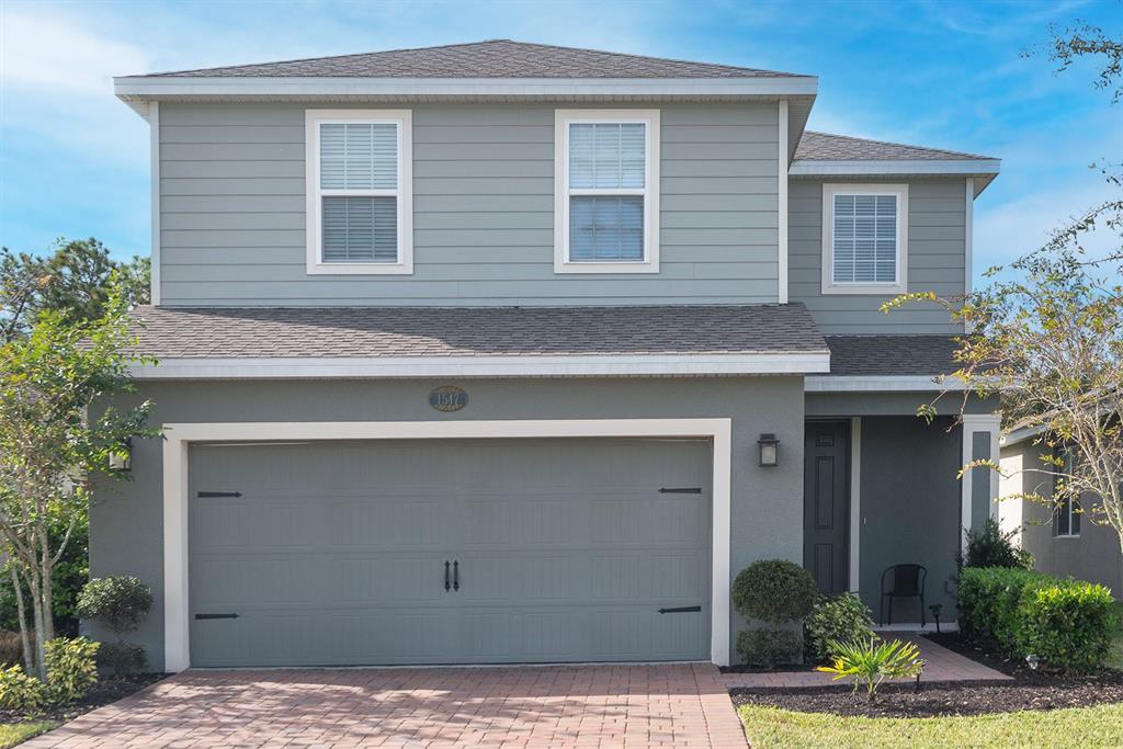 a front view of a house with garage