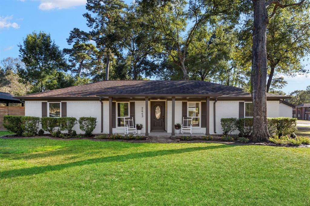 a front view of house with yard outdoor seating and green space