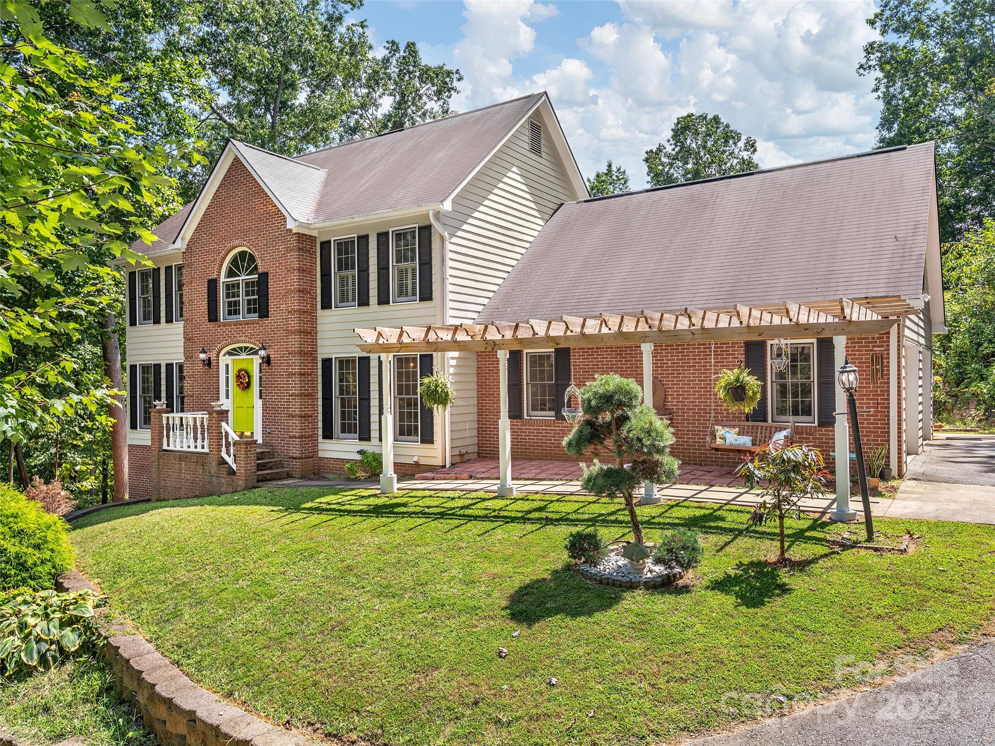 a view of a house with backyard sitting area and garden