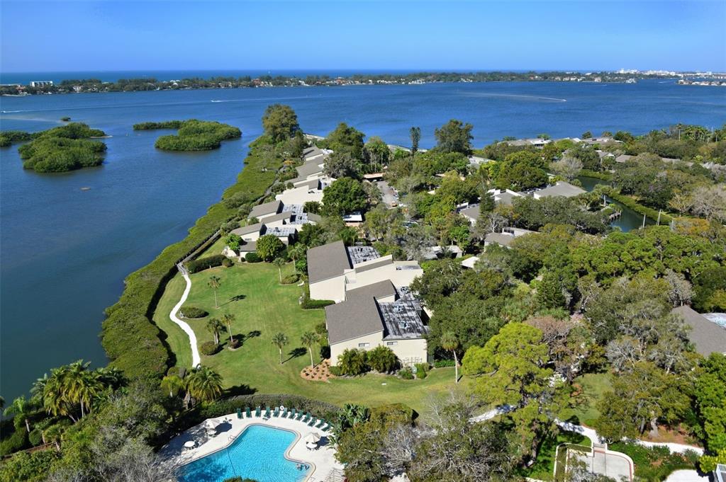 an aerial view of lake with residential houses with outdoor space