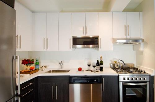 a kitchen with stainless steel appliances a sink a stove and cabinets