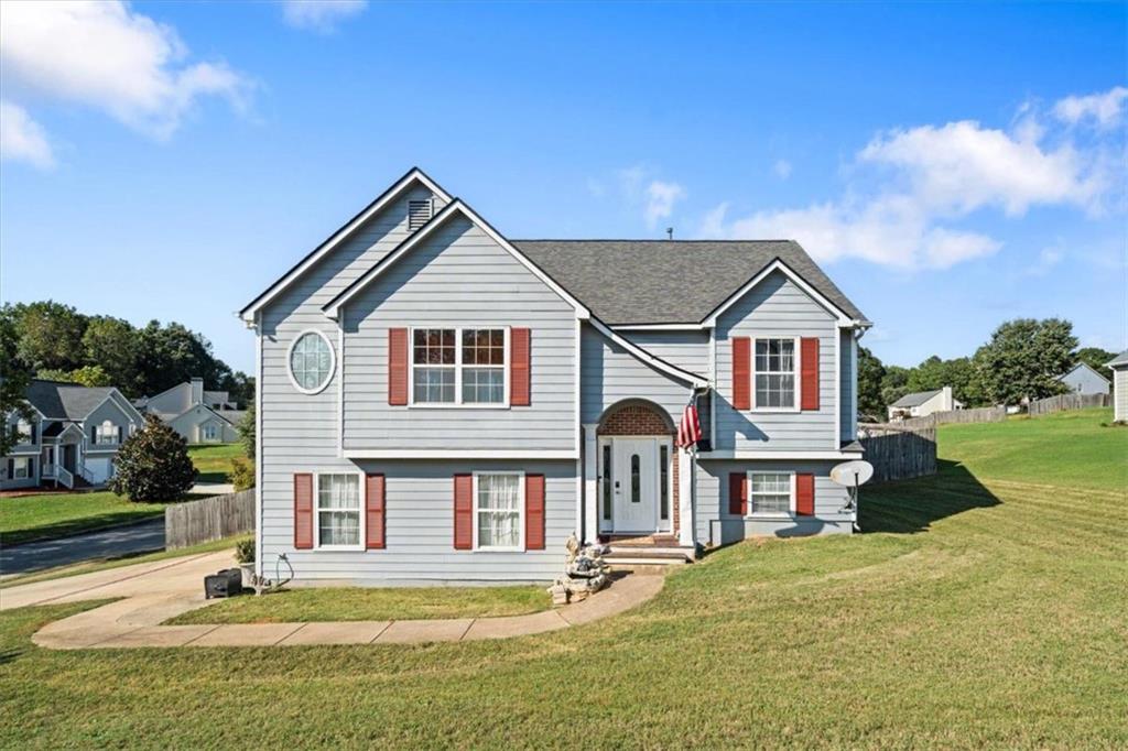 a front view of a house with a garden and yard