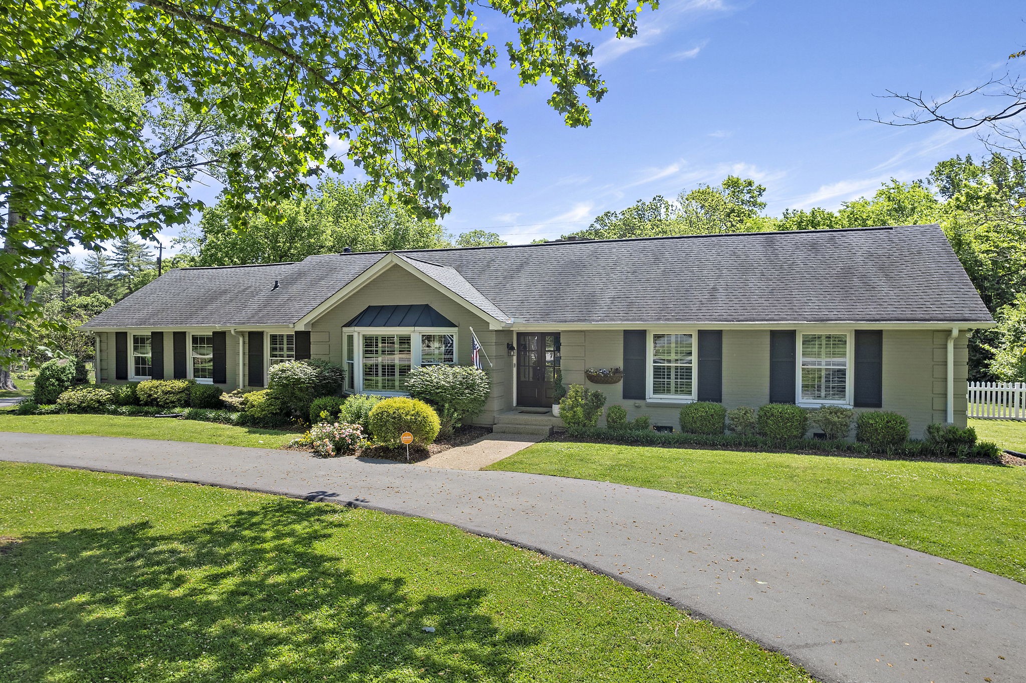 a front view of a house with garden