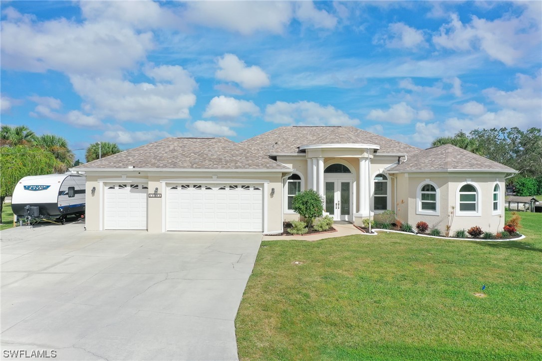 a front view of a house with yard and green space