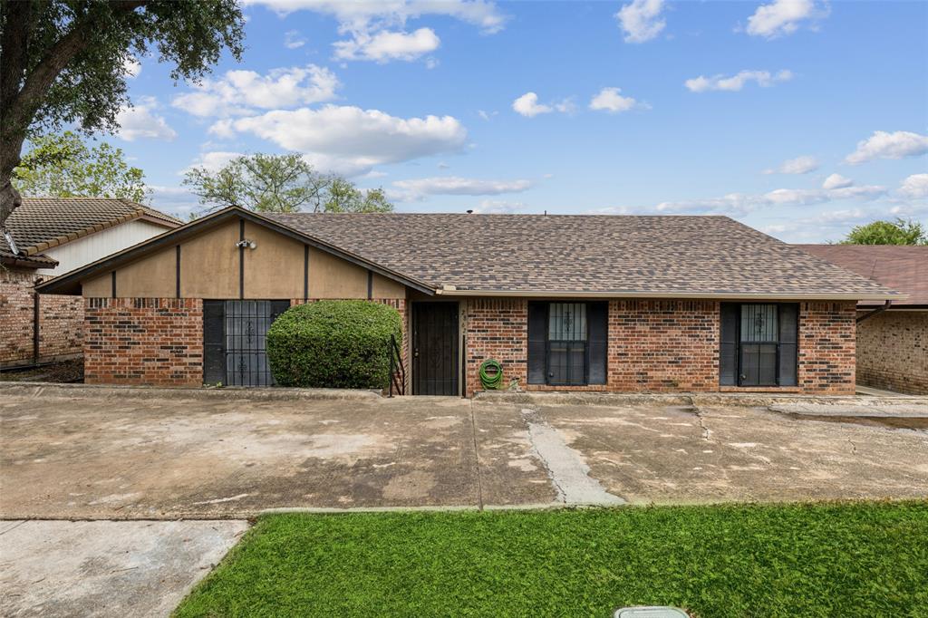 a view of a house with brick walls