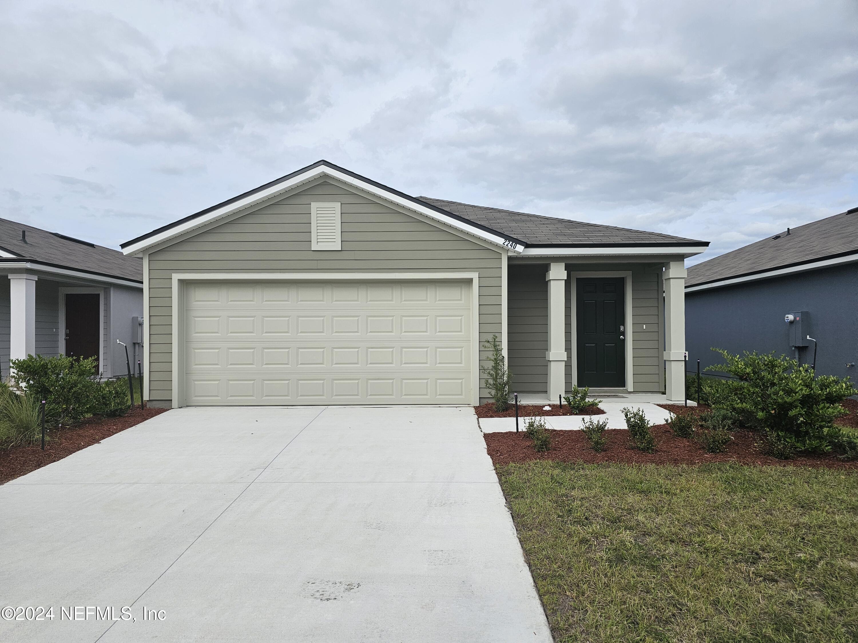 a front view of house with yard and green space