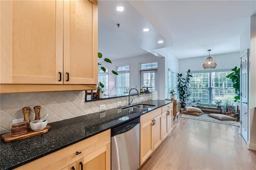 a kitchen with granite countertop a sink and a stove top oven