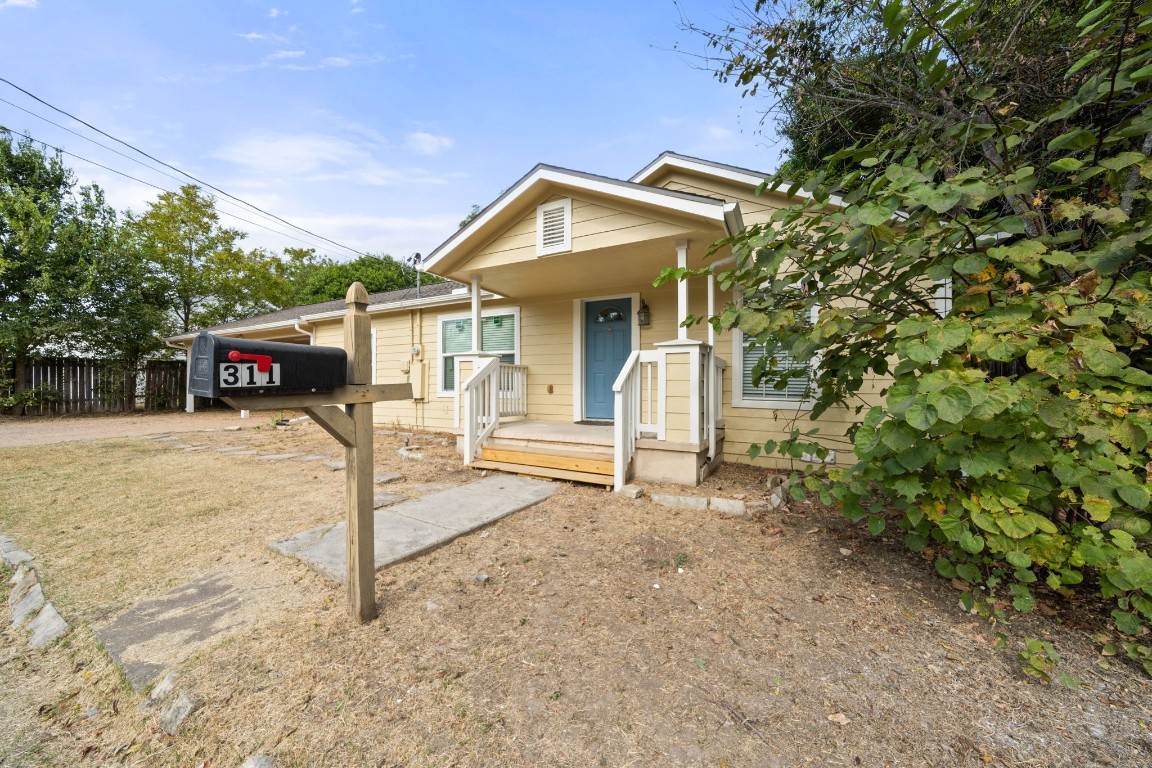 a view of a house with a yard and garage