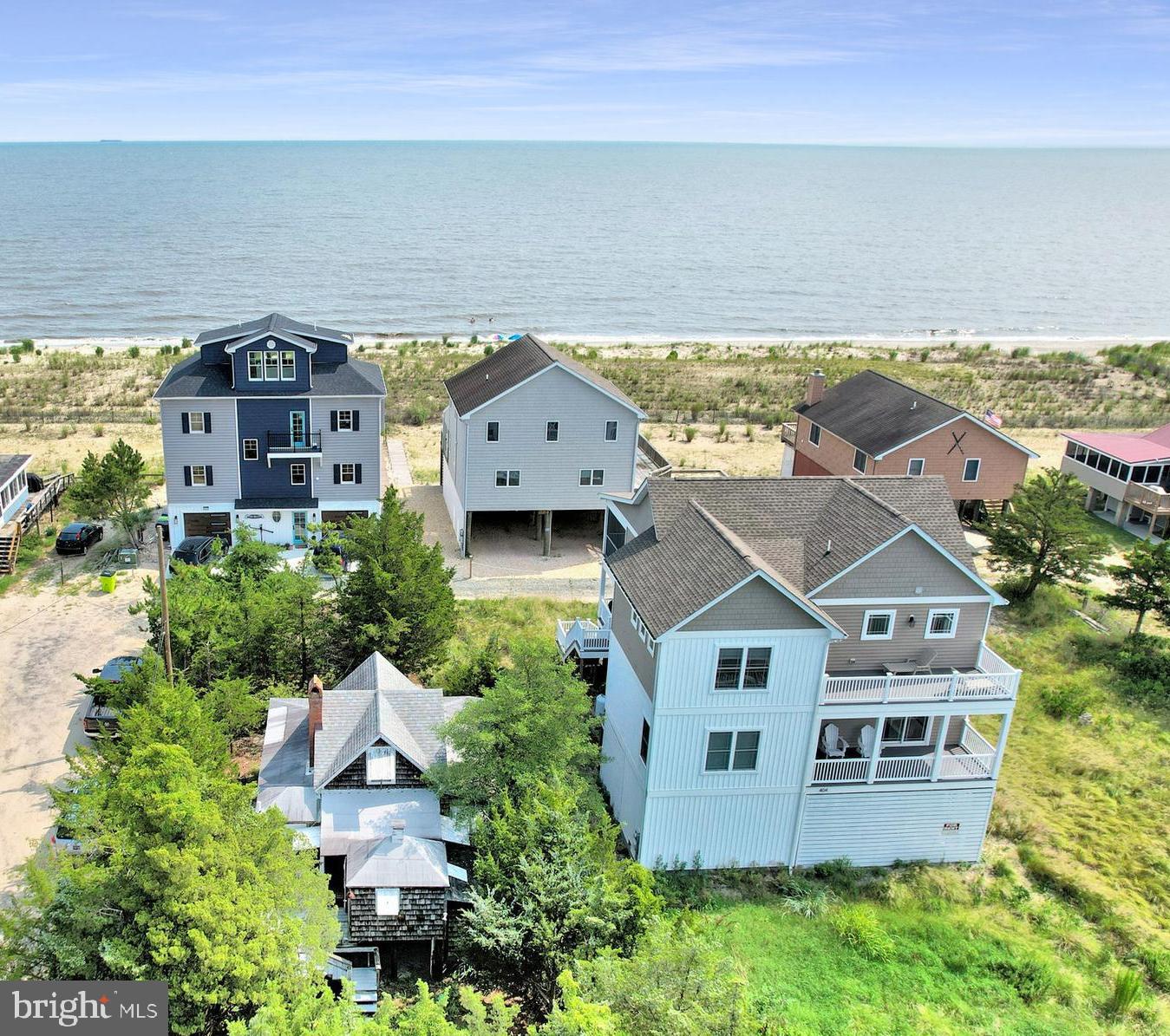 an aerial view of a house with a yard and lake view